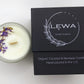 Top view of 'Confidence' Candle with dried floral decoration on top, beside the LEWA black signature box on white background.